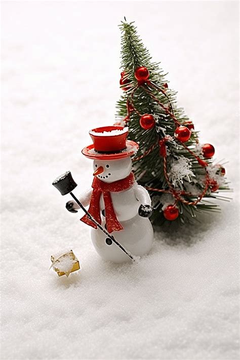 A Snowman With Red Bow Tying A Christmas Tree Background Wallpaper