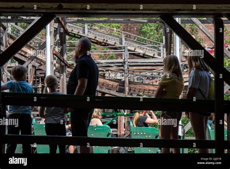 People Queuing For Traditional Vuoristorata Wooden Roller Coaster Ride