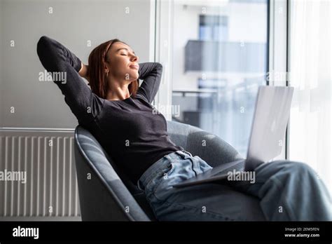 Woman Sitting On Rocking Chair Put Hands Behind Head Resting On Lazy