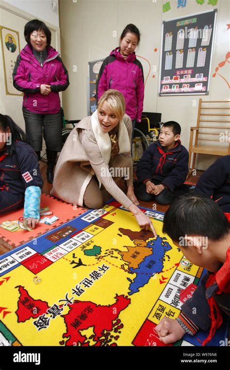 Princess Charlene Wittstock of Monaco plays with young students during