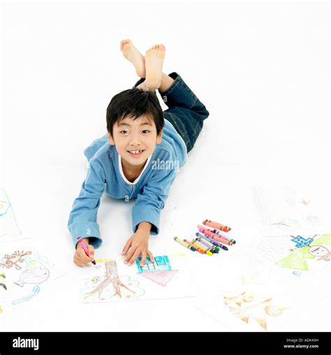 a boy drawing a picture with a smile Stock Photo - Alamy