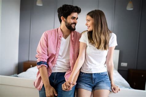 Beautiful Happy Couple Of Young Lovers Are Hugging Indoors At Home With Love And Tenderness