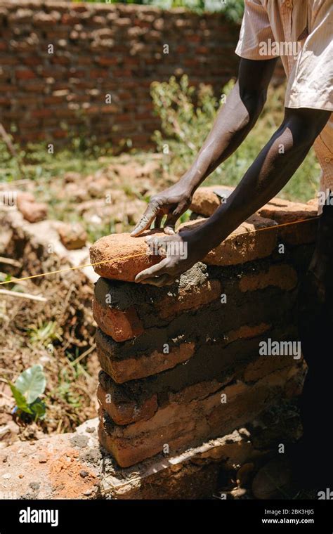 Man Building A Brick Wall In Uganda Africa Stock Photo Alamy