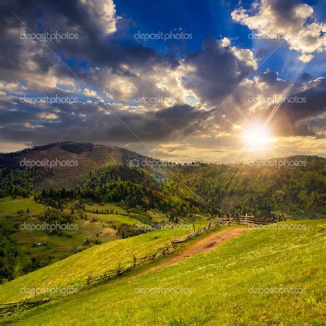 Fence On Hillside Meadow In Mountain At Sunset Stock Photo By Pellinni