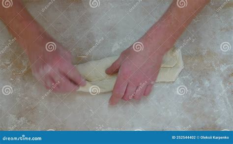 Closeup Shot Of Hands Of Senior Bakery Chef Applying Flour On Dough