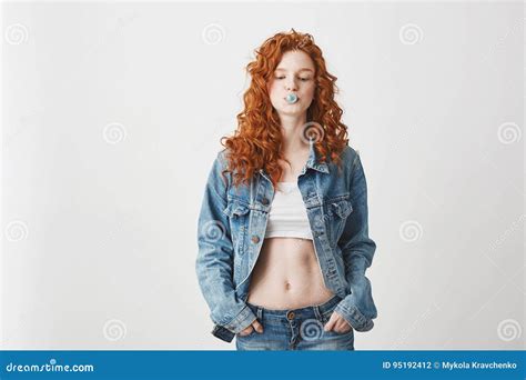 Cool Brutal Redhead Girl In Jean Jacket Chewing Gum Over White