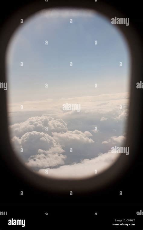 View of clouds through airplane window Stock Photo - Alamy