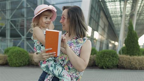 Mother and daughter near airport. Woman hold passports and tickets in