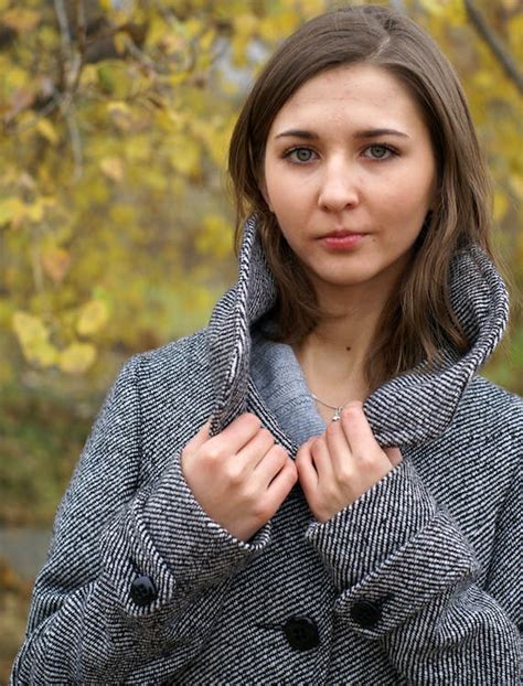 Young Woman Posing In A Grey Tweed Pea Coat · Free Stock Photo