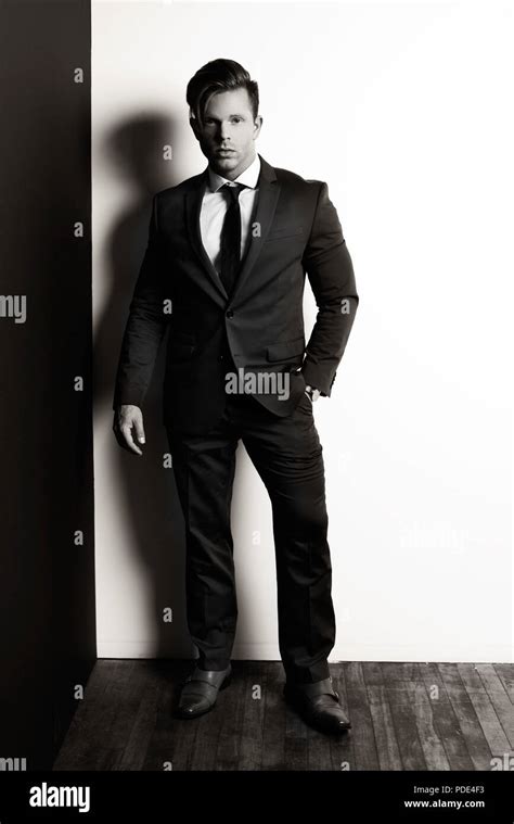 High Fashion. Black and white mens fashion stock photo. Handsome man in a suit Stock Photo - Alamy