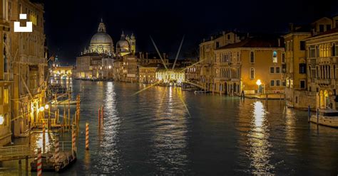 Brown And White Concrete Building Near Body Of Water During Night Time Photo Free Building