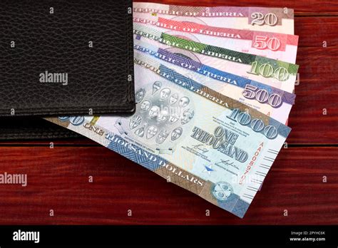 Liberian dollar - new series of banknotes in the black wallet Stock ...