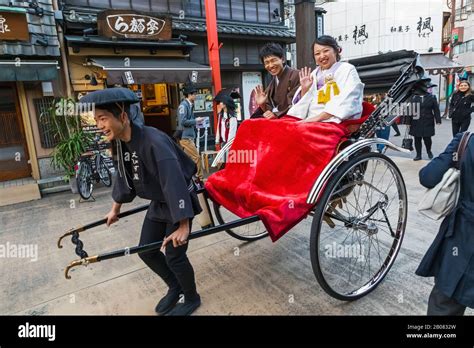 Japan Honshu Tokyo Asakusa Couple Riding In Rickshaw Stock Photo