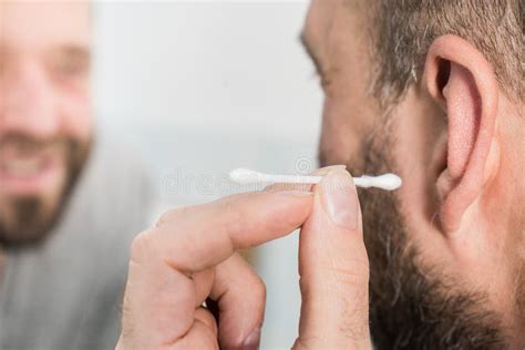 Man Removing Wax From Ear Using Q Tip Stock Image Image Of Cleaning