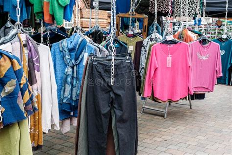 street market stall selling womens fashion clothing editorial
