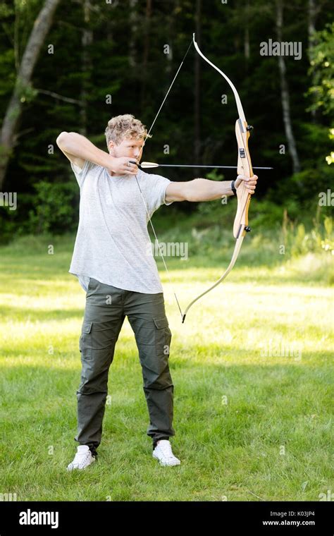 Man shooting bow arrow in hi-res stock photography and images - Alamy