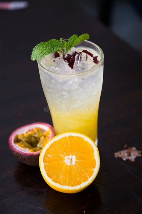 Tropical Cocktail With Passion Fruit Orange And Mint On A Dark