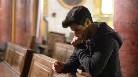 A Young Man Praying To God The Prayer Is Performed In The House Stock