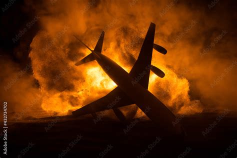 Air Crash. Burning falling plane. The plane crashed to the ground. Decorated with toy at dark ...