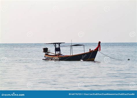 Thai Longtail Boat In The Sea At Sunset With Big Red Sun And Mountains