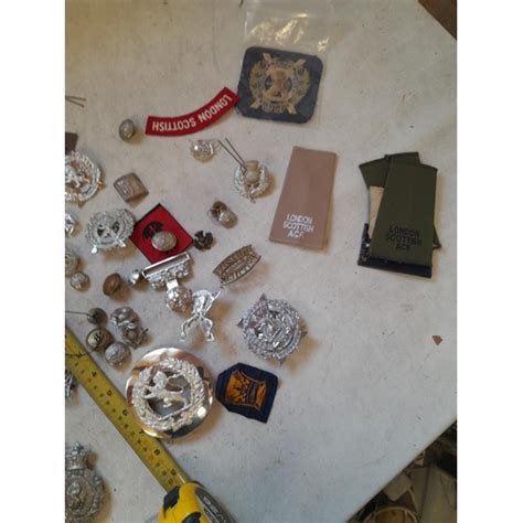 Assorted Military Issue Cap Lapel Badges Buckles And Related Items