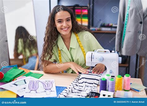 Young Beautiful Hispanic Woman Tailor Smiling Confident Using Sewing