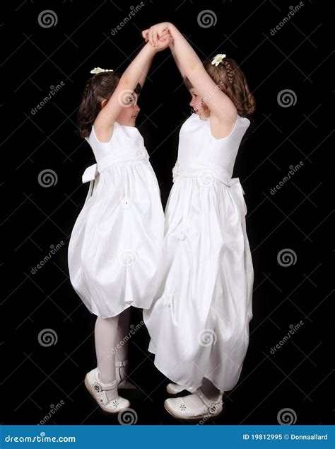 Playful Twin Sisters with Hands Joined in the Air Stock Image - Image