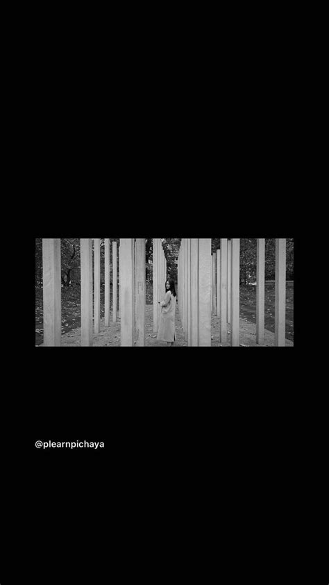 Black And White Photograph Of Two People Standing In Front Of Columns