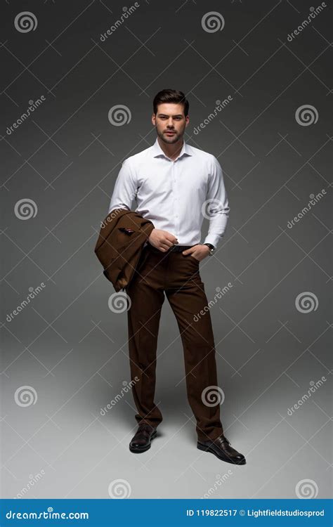 Stylish Businessman Standing With Jacket On One Hand Stock Image