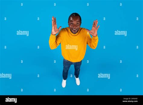 High Angle View Of Emotional Black Man Raising Hands Up Stock Photo Alamy