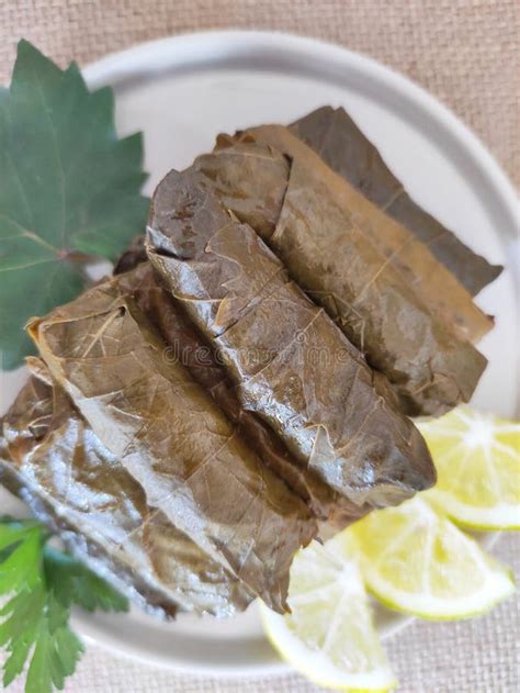 Traditional Oriental Turkish Dolma Made of Grape Leaves Stuffed with Rice on Decorative Plate ...