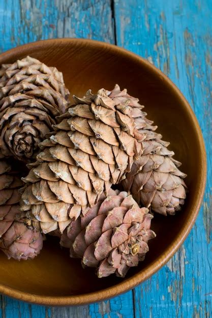 Premium Photo Cedar Cones With Pine Nuts In A Bowl