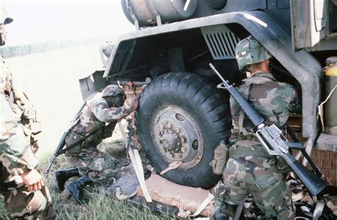 Members Of The 1ST Battalion 39th Field Artillery Work Together To