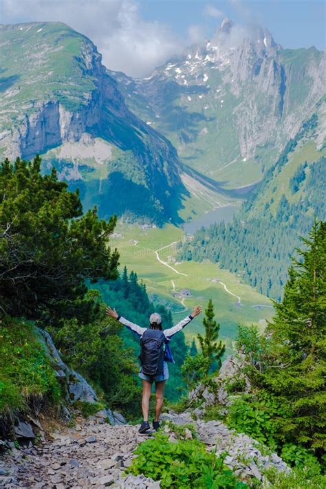 Asian Women Hiking In The Swiss Alps Mountains At Summer Vacation With