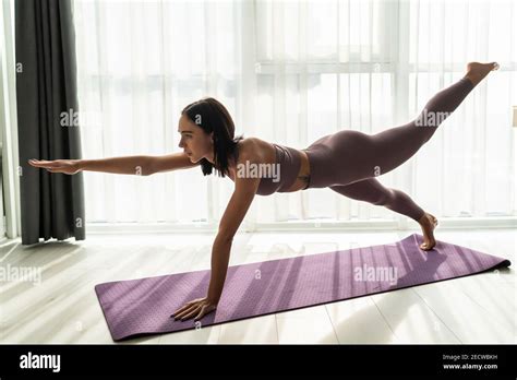 Sporty Woman In Grey Sportswear Bra And Leggings Practicing Yoga