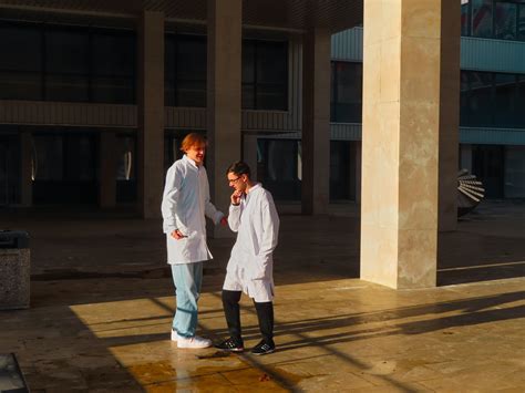 Men in White Medical Uniform Walking on Building Square · Free Stock Photo