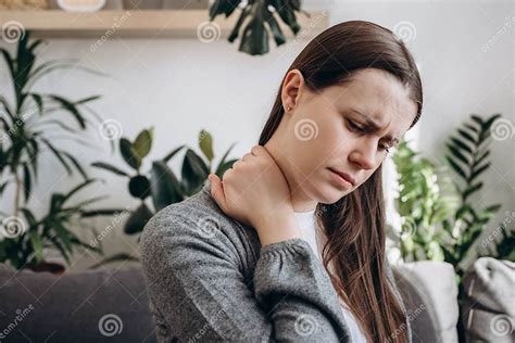 Selective Focus Of Unhealthy Young Woman Having Neck Pain Sitting On