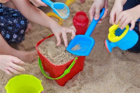 Premium Photo Close Up Of Hands Holding Sand On Beach