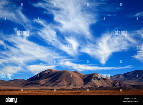 Unusual funnel shaped cirrus cloud formations on the border of the ...