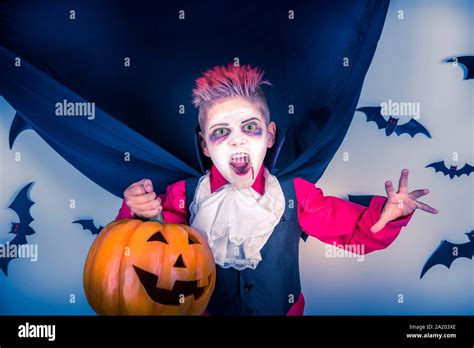 Halloween kids. Spooky Boy with a Halloween costume of a vampire Dracula with Halloween pumpkin ...