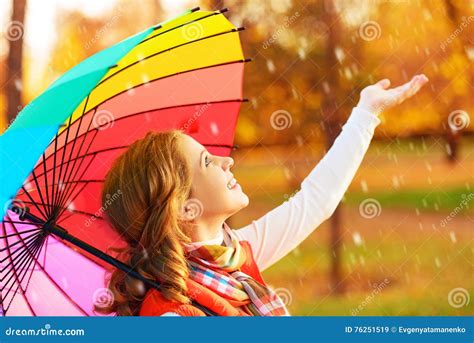 Happy Woman With Rainbow Multicolored Umbrella Under Rain In Par Stock