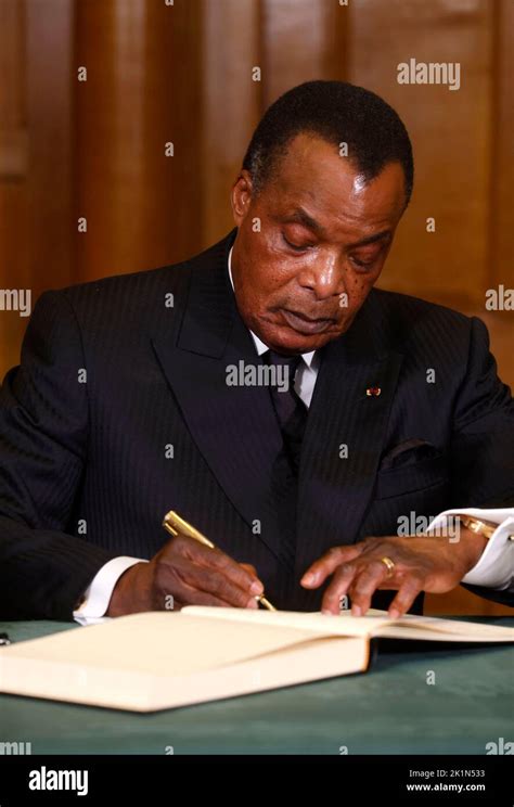 President of the Republic of Congo, Denis Sassou Nguesso signs a book ...