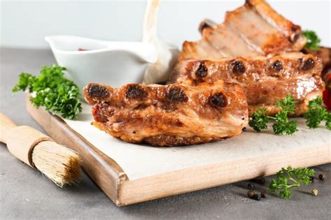 Premium Photo Wooden Board With Delicious Grilled Ribs On Table