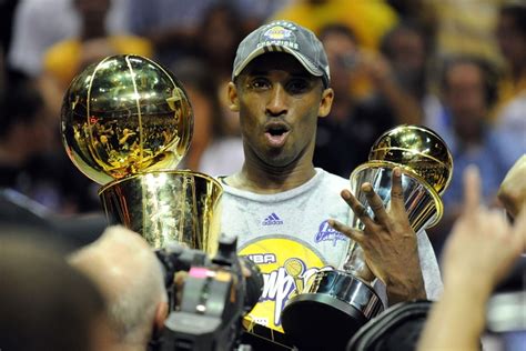 Kobe Bryant with all his trophies | HoopsHype