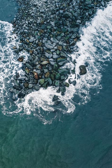 Aerial View of Ocean with Rocks and Water