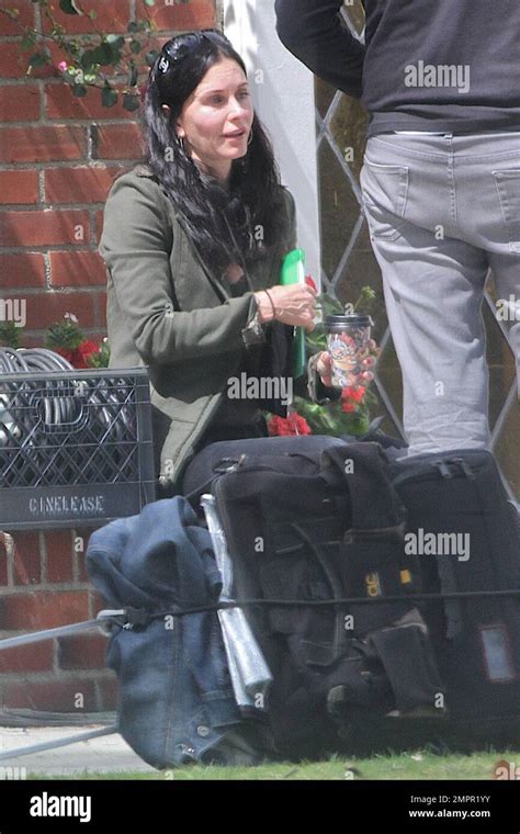 Courteney Cox looks to be wearing no makeup as she works on her script ...