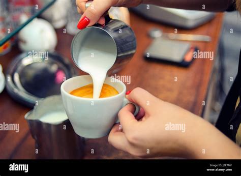 Barista Pours Gentle Whipped Milk Into The Cup For The Cappuccino Soft