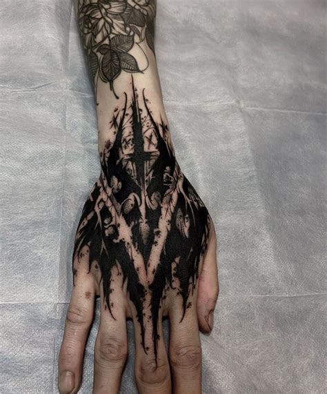 A Person S Hand Covered In Black Ink With An Intricate Design On The Palm