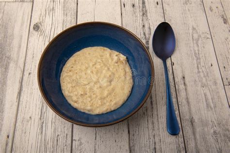 Bowl Of Plain Porridge Oats On A Wooden Table Stock Photo Image Of