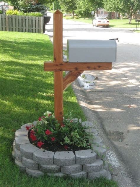 A Wooden Cross Sitting On The Side Of A Road Next To A Flower Pot